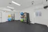 Modern fitness room featuring various workout equipment and colorful exercise balls, ideal for a healthy lifestyle.