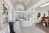 Elegant reception area featuring a modern design with high ceilings, stylish artwork, and abundant natural light.