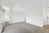 Bright and spacious living area with plush carpet, sliding glass door, and modern white walls, ideal for a cozy yet contemporary home setting.