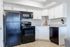 The Social Block Kitchen with White Cabinetry and Black Appliances