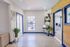 Bright and modern living space featuring sleek wooden floors, vibrant blue accents, and abundant natural light, perfect for a stylish and inviting atmosphere.