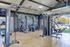 Modern, spacious fitness center in luxury apartment complex featuring state-of-the-art workout equipment and bright, airy design.