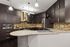 Modern kitchen with sleek dark wood cabinetry, stainless steel appliances, and elegant pendant lighting.