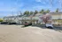 Charming suburban townhouses with blooming cherry blossom tree and ample parking, showcasing modern living in a serene setting.