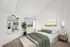 Elegant bedroom with a modern design, featuring a cozy bed with green accents, natural light through a large window, and stylish decor including wall shelves and artwork.