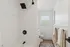 Elegant bathroom with sleek modern fixtures, featuring a spacious shower and stylish decor with natural light streaming through the window.