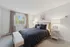 Elegant and inviting bedroom with a plush double bed, natural light from a large window, and modern decor for a cozy atmosphere.