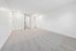 Spacious and bright bedroom with plush carpet, fresh white walls, and ample closet space.