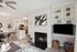 Chic open-plan living space with a cozy fireplace, modern kitchen, and elegant dining area, perfect for stylish living.