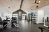 Modern gym with vaulted wood ceiling, featuring state-of-the-art fitness equipment and vibrant exercise space.