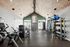 Modern fitness center with state-of-the-art equipment, vaulted ceilings, and a welcoming atmosphere.