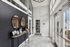 Elegant apartment entrance with stylish mirrors, chic decor, and ample natural light through large windows.