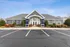 Elegant apartment complex with charming landscaping and modern architecture under a clear blue sky.
