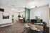 Modern apartment office space with stylish decor, fresh greenery, and vibrant artwork creating an inviting atmosphere.