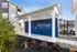 Elegant outdoor mail station at Arrive Odenton North, featuring modern blue lockers and lush landscaping.