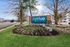 Welcome to Arrive Odenton South, featuring a beautifully landscaped entrance with modern stonework and lush greenery, creating a warm and inviting atmosphere.