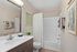 Modern bathroom with elegant fixtures, chic vanity, and inviting decor, offering a serene ambiance.