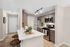 Modern kitchen featuring sleek stainless steel appliances, elegant cabinetry, and a stylish marble countertop with inviting bar seating.