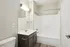 Sleek bathroom design featuring modern fixtures, elegant vanity, and spacious tub with neutral tones.