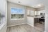 Bright open kitchen with modern appliances, sleek cabinetry, and expansive windows offering natural light and serene views.
