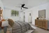 Inviting bedroom featuring a cozy bed, stylish decor, and natural light from a large window.