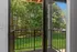 Inviting balcony view overlooking lush green trees and a serene outdoor landscape, perfect for relaxation and nature appreciation.