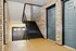 Inviting apartment corridor with stylish brick walls, wooden floors, and modern door design.