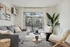 Inviting living room with modern gray sofa, stylish chairs, and large window offering a bright, airy feel and serene outdoor view.