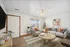 Contemporary living room with cozy grey seating, vibrant cushions, and elegant decor, bathed in natural light.