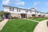 Charming townhouse exterior with manicured lawns and welcoming entrances, perfect for a cozy and stylish living experience.