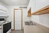 Modern kitchen with sleek cabinetry, stainless steel double sink, and equipped with stove and microwave in an inviting space.