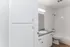 Bright and modern bathroom with white cabinetry, sleek sink, and inviting bathtub.