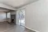 Charming living room with elegant fireplace and large sliding glass doors opening to a serene backyard.