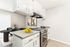 Chic modern kitchen with sleek white cabinetry, sophisticated dining area, and stylish decor.