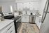 Modern kitchen with sleek white cabinets, stainless steel appliances, and a cozy breakfast nook.