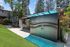Inviting outdoor view of Arrive Thousand Oaks apartment community featuring lush green lawns, modern architecture, and convenient parcel locker.