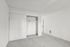 Spacious, bright bedroom with a large built-in closet, featuring plush carpeting and modern design.