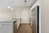 Modern kitchen with sleek stainless steel appliances, elegant granite countertops, and stylish pendant lighting.