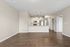 Stylish open-plan living area with modern kitchen, sleek cabinetry, and inviting hardwood floors, ideal for contemporary living.