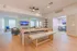Modern open-concept living room with stylish wooden flooring, elegant dining area, and cozy seating, perfect for entertaining.