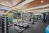 Bright, modern gym with state-of-the-art equipment, large windows, and inviting workout atmosphere.