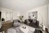 Inviting modern living room with stylish furniture, abstract art, and warm lighting, perfect for relaxation.