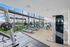 Modern apartment fitness center with panoramic views, state-of-the-art exercise equipment, and ample natural light.