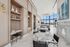Luxurious modern lounge with elegant marble tables, cozy fireplace, and expansive windows offering stunning views.