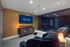 Cozy theater room with luxurious seating and ambient candle lighting, perfect for relaxation and entertainment at Arrive Upper Kirby.