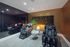 Luxury relaxation room with sleek massage chairs, ambient lighting, and elegant decor, perfect for unwinding.
