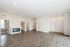 Modern open-concept apartment with elegant hardwood floors, contemporary lighting, and multiple doorways leading to spacious rooms.