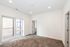 Bright and spacious empty room with plush carpeting, large windows, and recessed lighting, perfect for customization.