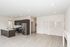 Modern open-concept living space with sleek kitchen, stainless steel appliances, and elegant hardwood floors.