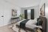 Bright and stylish bedroom with modern furnishings, featuring a large window, elegant decor, and cozy ambiance.